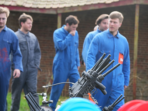 Players adults running behind some bunkers during a game of paintball in Ottignies