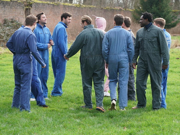 Players adults running between the trees during a game of paintball in the forest near Tervuren
